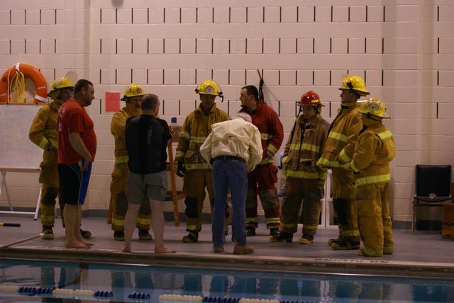 A dry group of firefighters receive instruction from Team Lifeguard Systems President and Founder Butch Hendrick prior to taking the plunge...Lifeguard Systems &quot;Drown Proofing Firefighter Turn Out Gear&quot; 1/6/2012